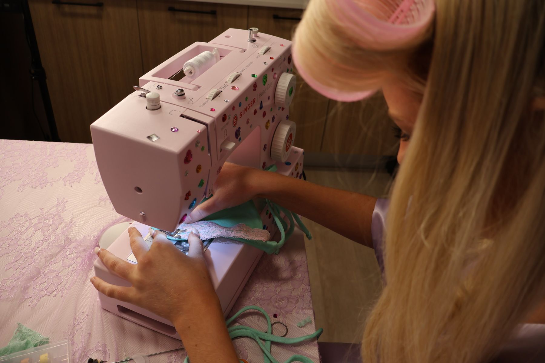 Sewing a mint bikini in hair rollers